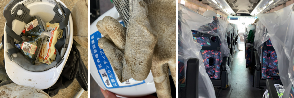 泥まみれのズボンの足の間、ヘルメットに入れたおにぎりと栄養食、汚れた手袋、座席にビニールシートが張られたバスの車内。